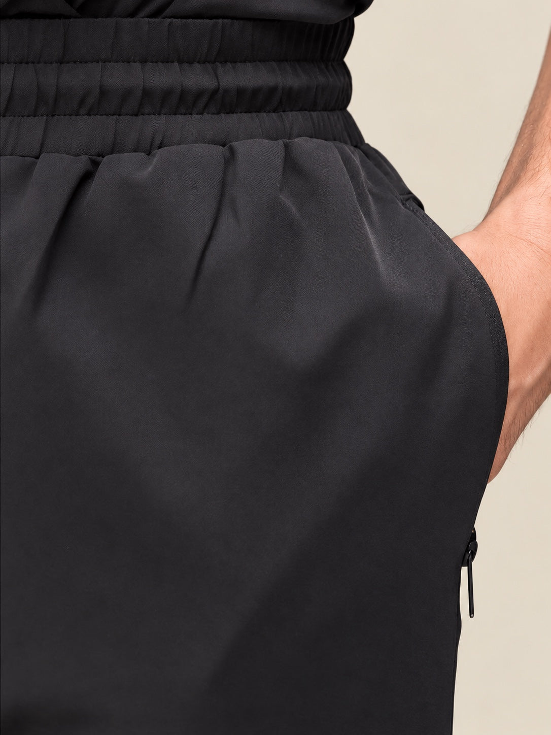 Close-up of the Antero trouser waistband, fabric and zipped side pocket